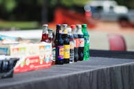 pexels-photo-1384039-1384039 Assorted bottles of soft drinks on a table outdoors during the day.