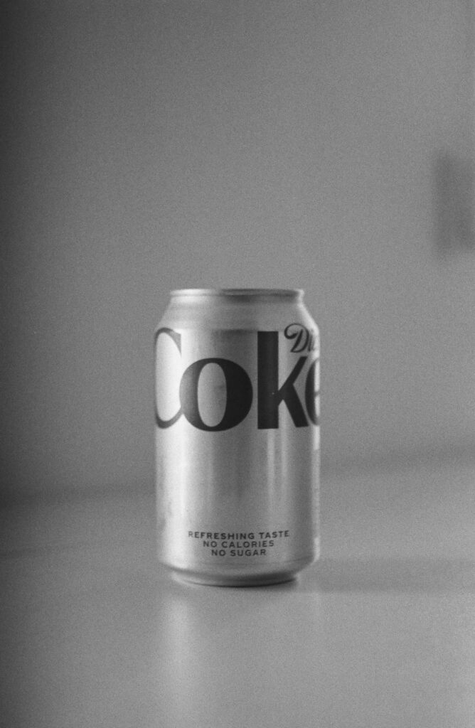 pexels-photo-27792684-27792684 Classic black and white photo of a Diet Coke can on a smooth surface.